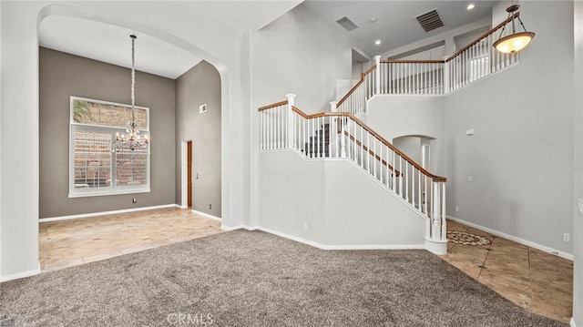 interior space featuring an inviting chandelier and a towering ceiling