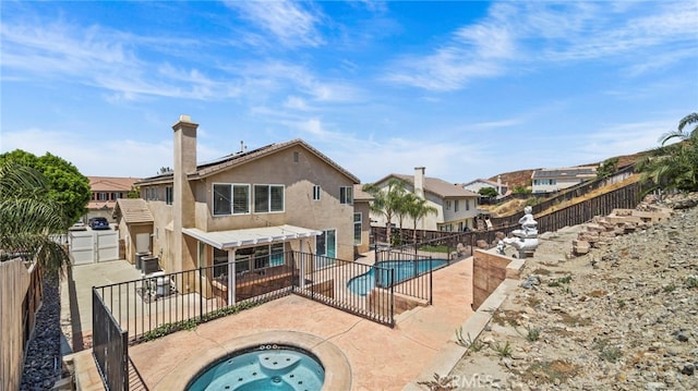 view of pool featuring a patio and an in ground hot tub