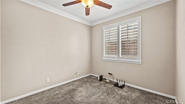 carpeted spare room with ceiling fan and ornamental molding