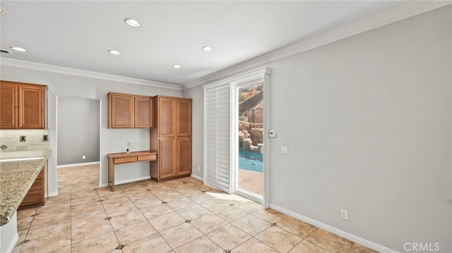 kitchen with light stone countertops and crown molding