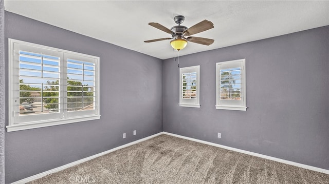 carpeted empty room featuring ceiling fan