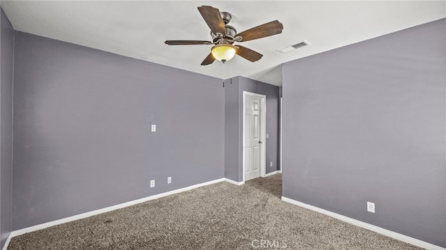 carpeted spare room with ceiling fan