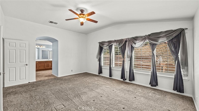 carpeted empty room with vaulted ceiling and ceiling fan