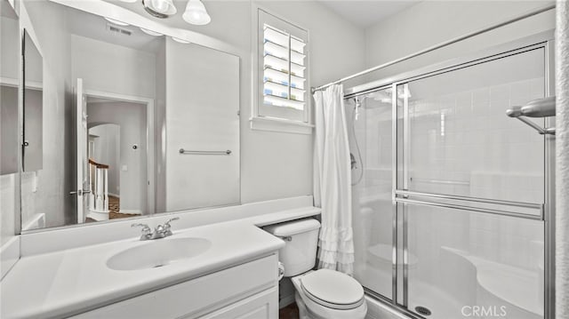 bathroom featuring a shower with curtain, vanity, and toilet