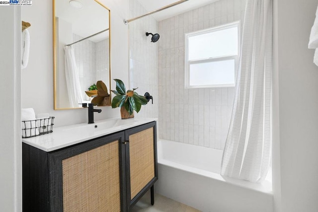 bathroom featuring shower / bath combo with shower curtain and vanity