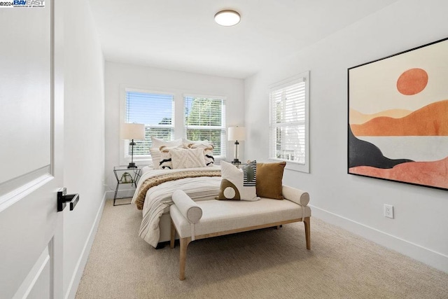 bedroom featuring light carpet