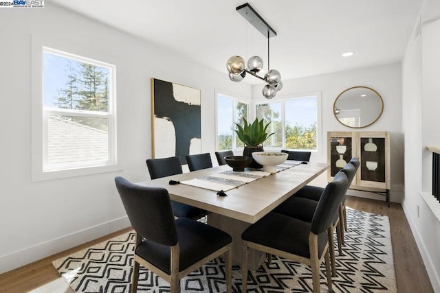 dining space with an inviting chandelier, hardwood / wood-style floors, and a wealth of natural light