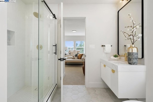 bathroom with vanity, a shower with shower door, and tile patterned floors