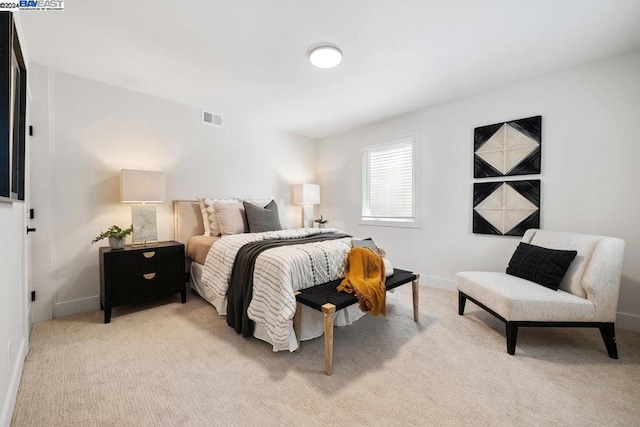 bedroom featuring light carpet