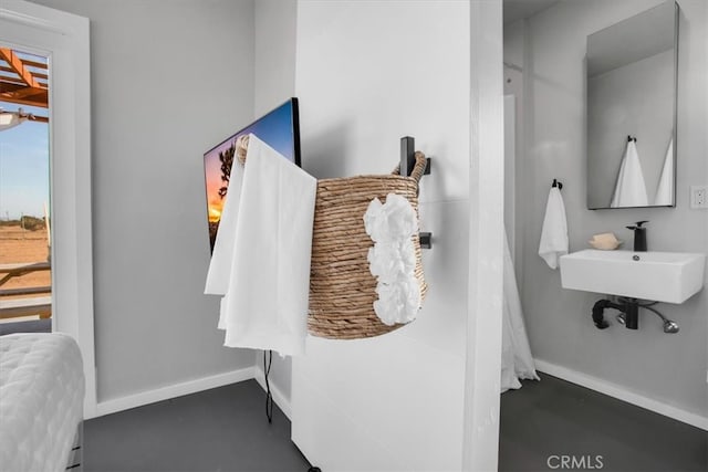 bathroom with sink and concrete flooring