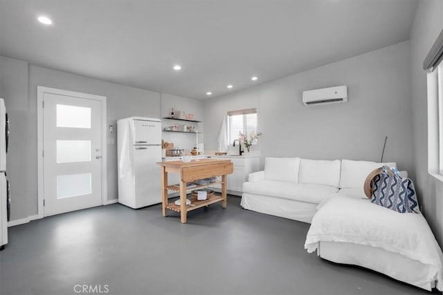 living room featuring finished concrete flooring, recessed lighting, and a wall mounted AC