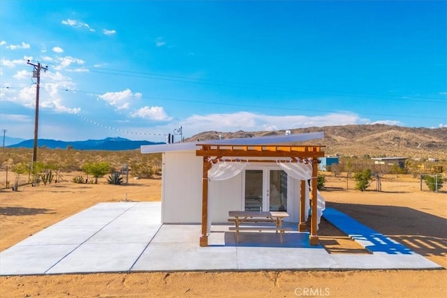 exterior space featuring a pergola and a mountain view