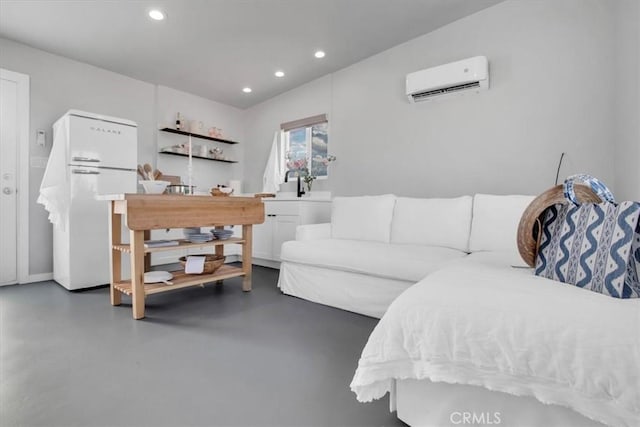 living area with recessed lighting, a wall unit AC, and finished concrete floors