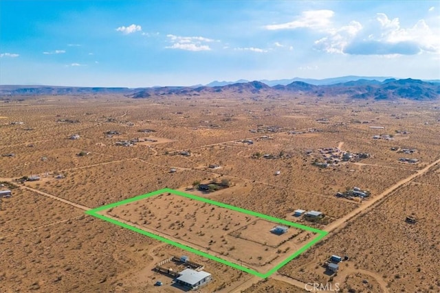 drone / aerial view with view of desert and a mountain view