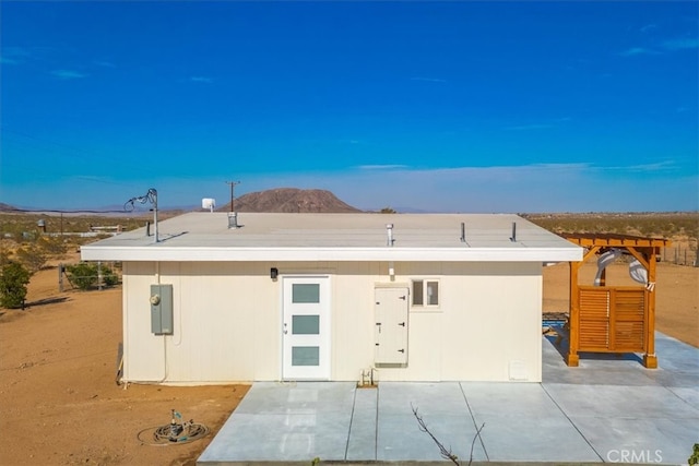 view of front of house with a mountain view and a patio area