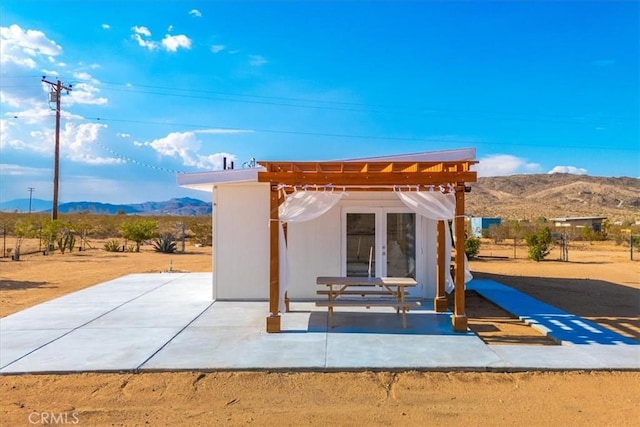 exterior space with a pergola and a mountain view