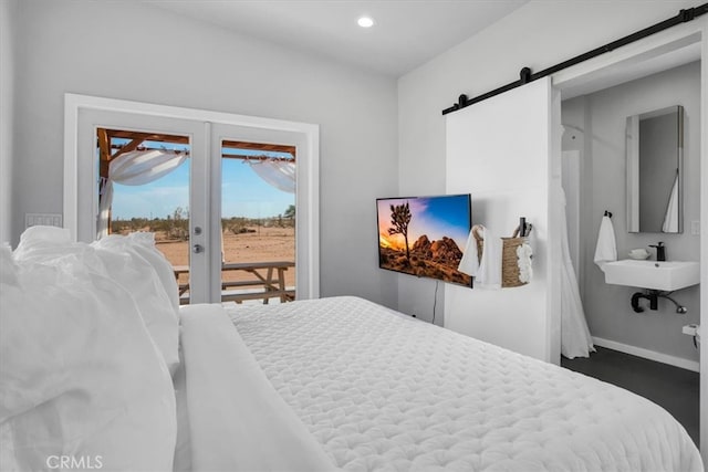 bedroom featuring a barn door and access to exterior