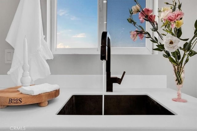 interior details with a sink and light countertops