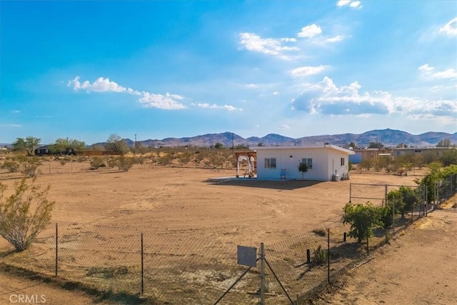 exterior space featuring a mountain view, a rural view, and fence