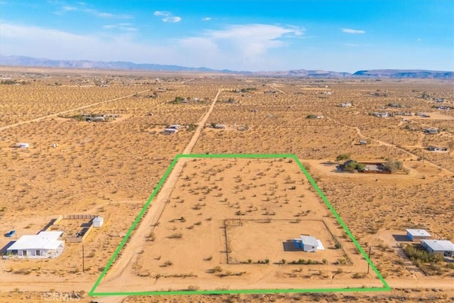 aerial view featuring a rural view, a mountain view, and a desert view