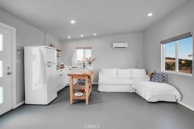 living room with a wall unit AC, concrete flooring, and vaulted ceiling