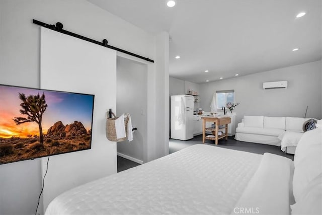 bedroom featuring a barn door, recessed lighting, a wall mounted air conditioner, and freestanding refrigerator