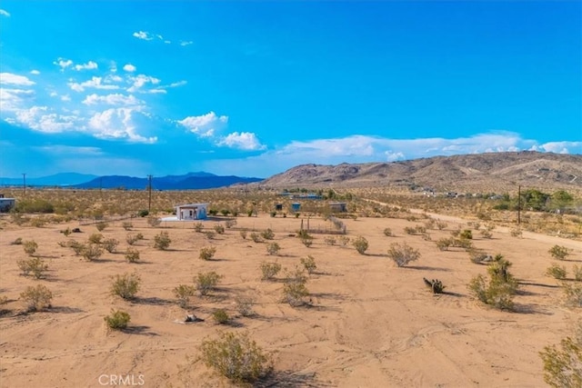 mountain view with view of desert and a rural view