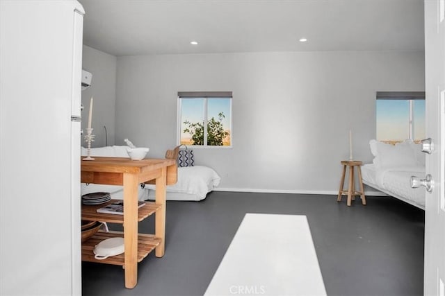 bedroom featuring recessed lighting, baseboards, and finished concrete floors