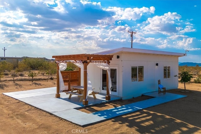 rear view of house with a patio and a pergola