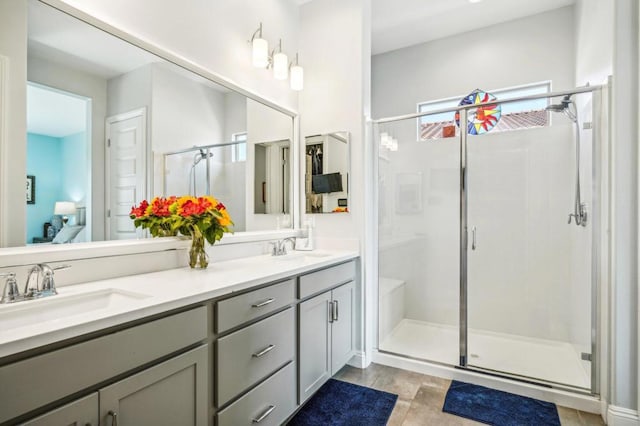 bathroom featuring walk in shower and vanity