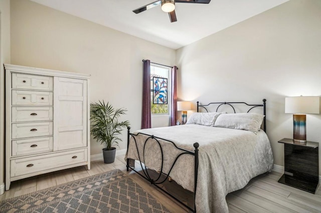 bedroom with ceiling fan and light hardwood / wood-style flooring