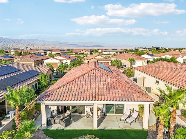 back of property with a patio, a mountain view, and cooling unit