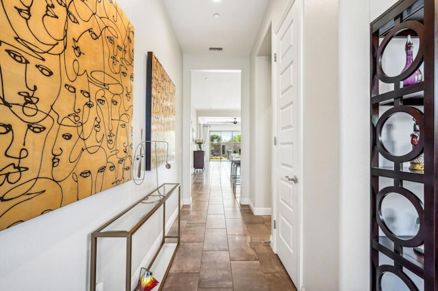 hall with dark tile patterned floors