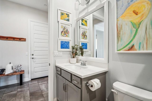 bathroom with tile patterned flooring, vanity, and toilet