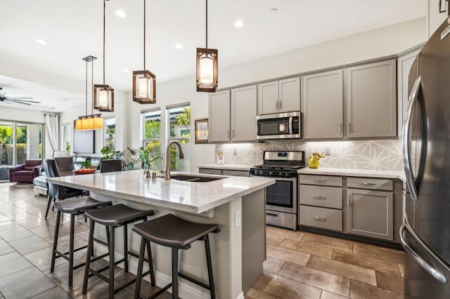 kitchen featuring sink, ceiling fan, stainless steel appliances, and a wealth of natural light