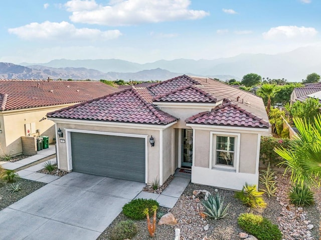 mediterranean / spanish-style house with a mountain view and a garage