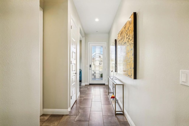 doorway to outside with dark tile patterned flooring