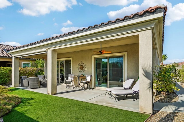 rear view of house featuring a yard, outdoor lounge area, ceiling fan, and a patio area