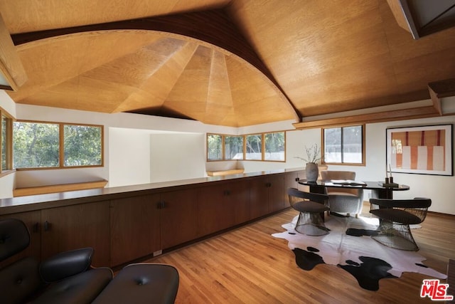 office space with light hardwood / wood-style flooring, lofted ceiling, and a wealth of natural light