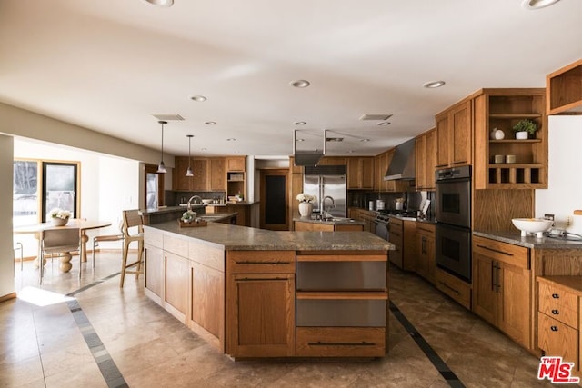 kitchen featuring a large island, decorative light fixtures, and tasteful backsplash