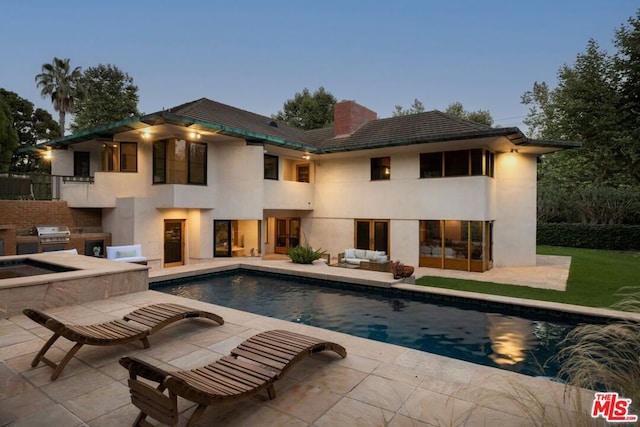 exterior space featuring a patio and exterior kitchen