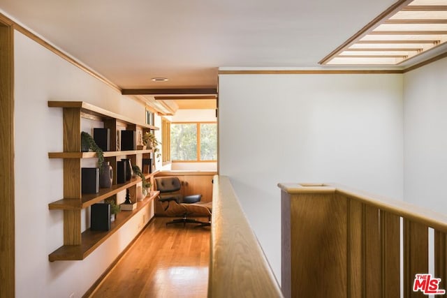 corridor featuring ornamental molding and light hardwood / wood-style floors