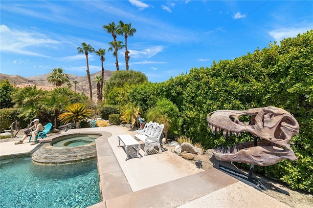 view of pool featuring a patio and an in ground hot tub