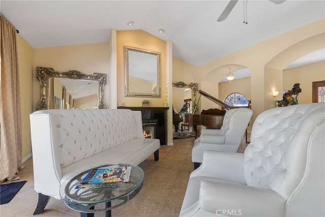 living room with vaulted ceiling, ceiling fan, and light tile patterned floors