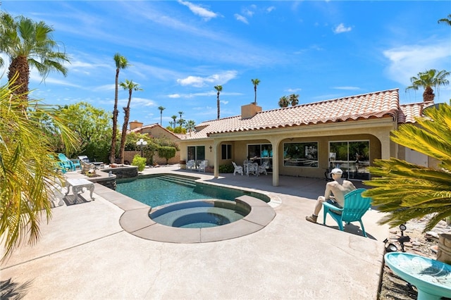 view of swimming pool featuring a patio and an in ground hot tub