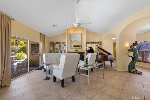 tiled dining room with lofted ceiling and ceiling fan