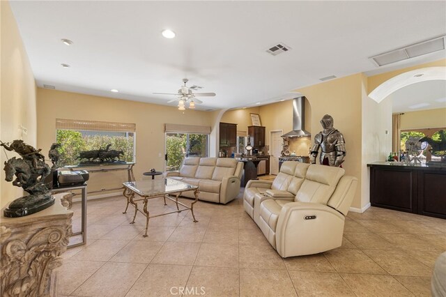 tiled living room featuring ceiling fan