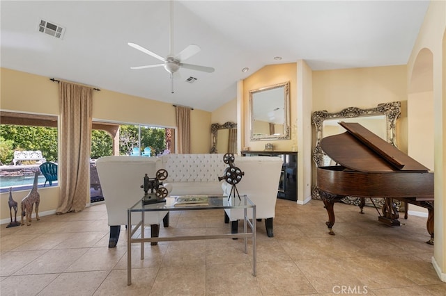 interior space featuring lofted ceiling, ceiling fan, and light tile patterned flooring