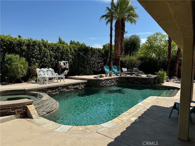 view of pool with a patio and an in ground hot tub