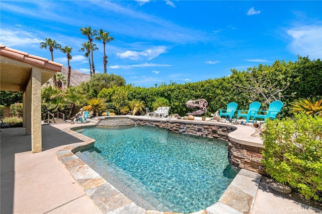 view of swimming pool featuring an in ground hot tub and a patio area